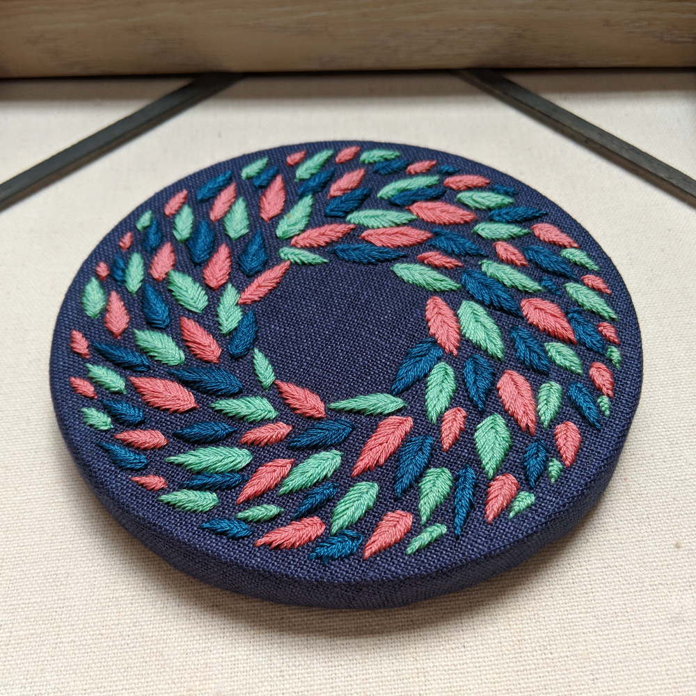 Multi Colored Wreath on Blue Linen